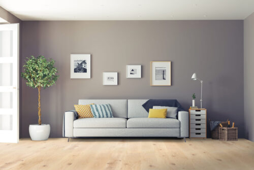 Modern living room with light hardwood flooring, gray sofa, and minimalist decor – premium wood floors by Rustic Wood Floor Supply.
