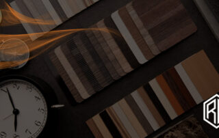 A variety of wood color swatches laid out on a dark surface with text overlay reading '7 Wood Color Trends To Transform Your Space in 2025' alongside a modern clock and compass.