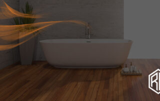 Modern bathroom featuring a freestanding white tub on warm hardwood flooring with a potted plant and decorative tray, illustrating how to choose the best flooring for a bathroom